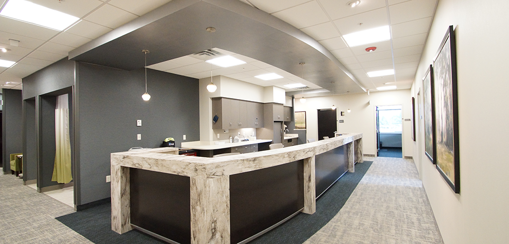 A custom designed nurses station with quartz countertops and custom millwork.
